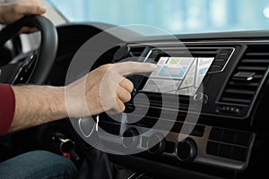 Man using navigation system while driving car