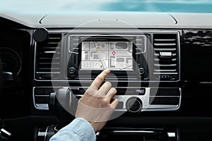 Man using navigation system while driving car, closeup