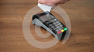 Man using payment terminal in cafeteria. Restaurant. Croissant and coffee.