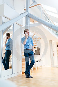 Man using phone in beautiful modern apartment