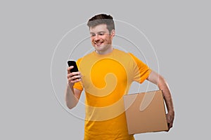 Man Using Phone with Box in Hands. Delivery Man With Box.