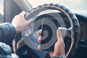 Man using a phone while driving a car