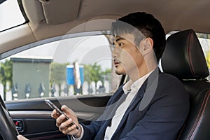 Man using phone while driving a car