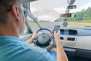 Man using phone while driving the car