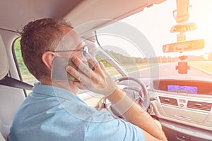 Man using phone while driving the car