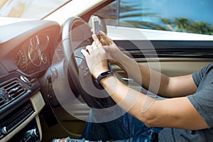 Man using phone while driving the car dangerous