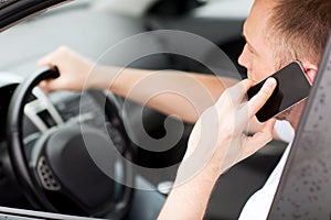 Man using phone while driving the car