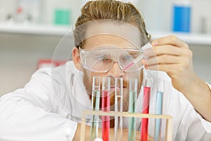 man using pipettes in lab photo