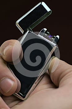 Man using a plasma arc lighter