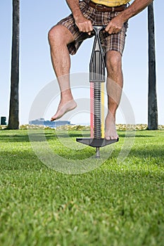 Man using a pogo stick photo