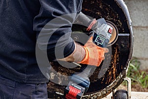 Man using portable grinder with sparkles