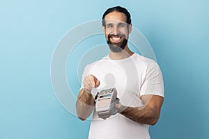 Man using pos terminal for contactless payment and credit card, paying for shopping.