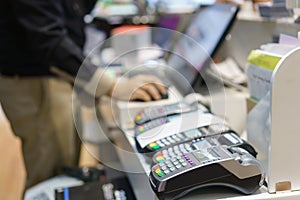 Man using pos terminal at the shop paying credit card for purch