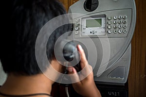 Man using public payphone