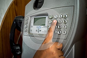 Man using public payphone