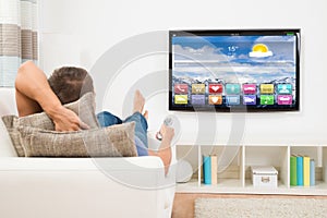 Man Using Remote Control In Front Of Television