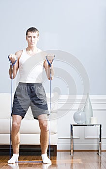 Man Using Resistance Bands in Living Room