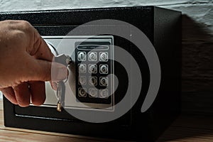 Man using safe key to open it