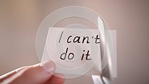 Man using scissors to remove the word can't to read I can do it concept for self belief