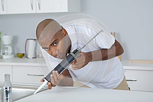 Man using sealant gun