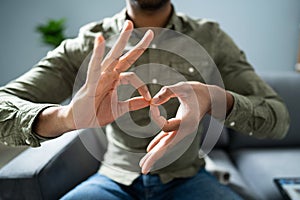 Man Using Sign Language To Communicate Against