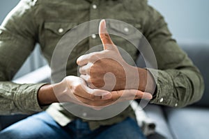 Man Using Sign Language To Communicate Against