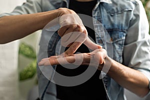 Man Using Sign Language To Communicate At Home