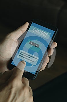 man using a simulated chatbot on his smartphone