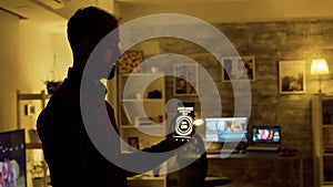 Man using a smart lights application to turn on the light bulbs in the house