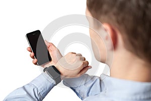 Man using smart watch and smart phone focus on watch on white background. App template