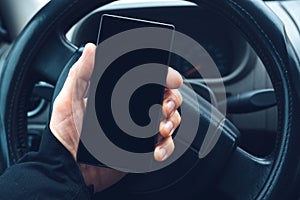 Man using smartphone in car