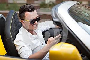 Man using smartphone in car