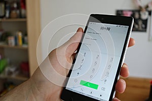 Man using smartphone dial phone number, making a call