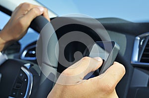 Man using a smartphone while driving a car