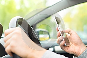 Man using smartphone while driving. Driver texting.