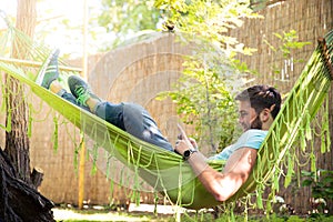Man using smartphone on hammok