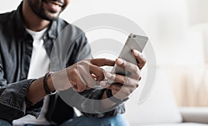 Man using smartphone at home. Closeup of male hands holding mobile phone, technology, apps, connection concept