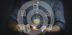 Man using smartphone with online documentation database and process automation to efficiently manage files.