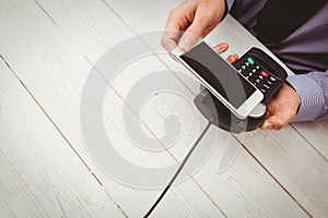 Man using smartphone to express pay