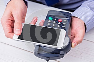 Man using smartphone to express pay