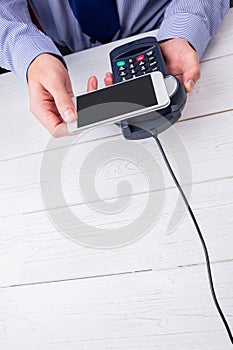 Man using smartphone to express pay