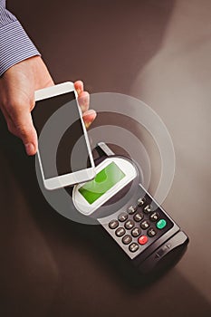 Man using smartphone to express pay