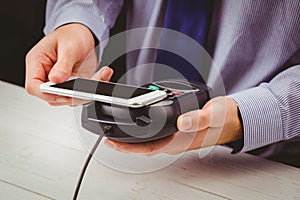 Man using smartphone to express pay