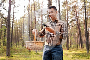 man using smartphone to identify mushroom