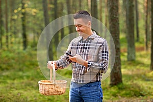 man using smartphone to identify mushroom