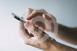 Man using smartphone to type text message