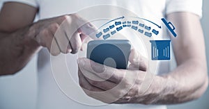 Man using smartphone. Trash can and files. Delete files