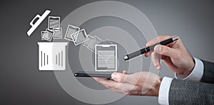 Man using smartphone. Trash can and files. Delete files