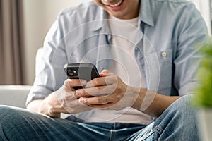 Man using smartphone typing, chatting conversation, watching video live streaming. Social network, technology concept