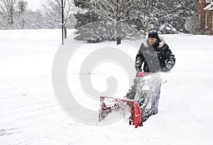 Man using a snow blowing machine, Canada photo